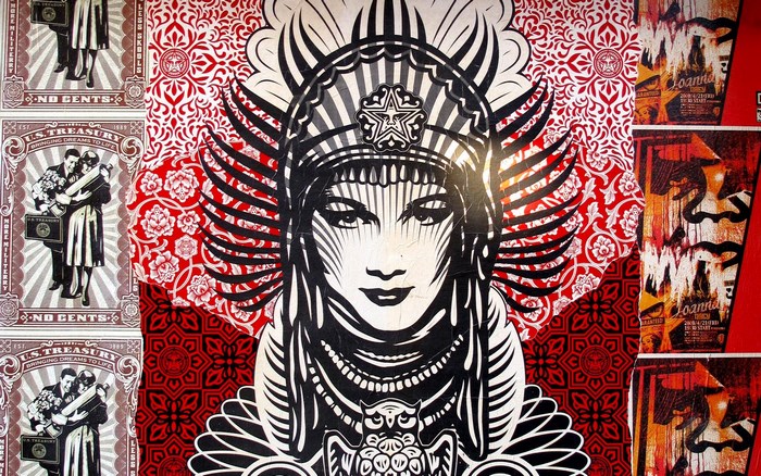 Obey Giant mural with female figure and propaganda posters