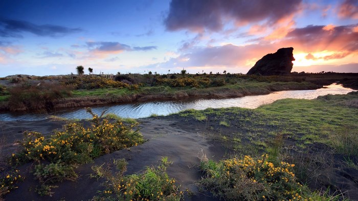 Coastal landscape with rock formation at sunset