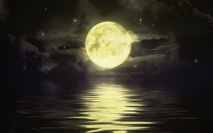 Full moon over water at night