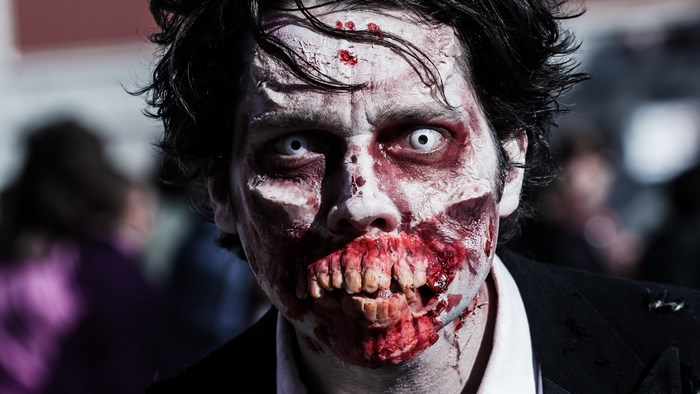 Zombie with bloody mouth and white eyes