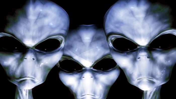 Three aliens with large black eyes