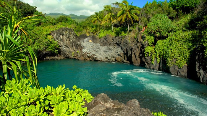 Tropical waterfall with rocky cliffs and lush vegetation