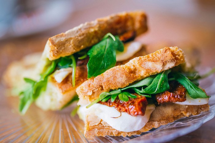 Sandwiches with mozzarella, sun-dried tomatoes, and arugula