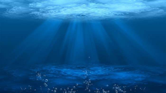 Underwater scene with sunbeams and bubbles