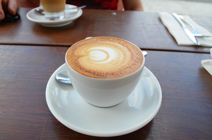 Latte art coffee cup on a wooden table