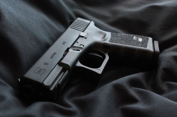 Glock 19 pistol on dark fabric
