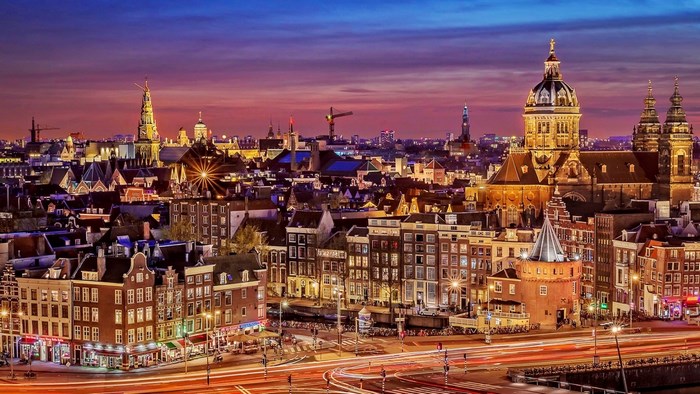 Amsterdam cityscape at dusk with canals and buildings