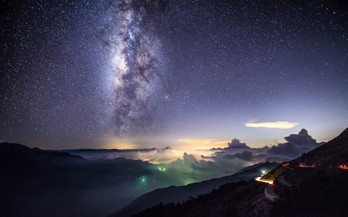 Milky Way over mountains and clouds