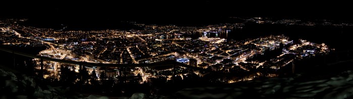 Cityscape at Night with Harbor and Mountains