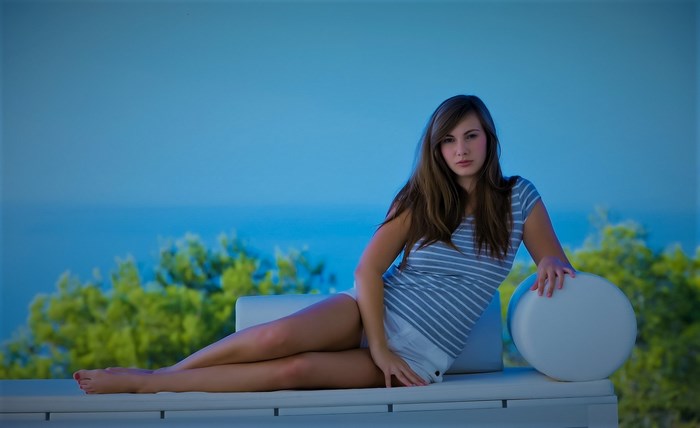 Connie Carter Relaxing Outdoors on White Lounge