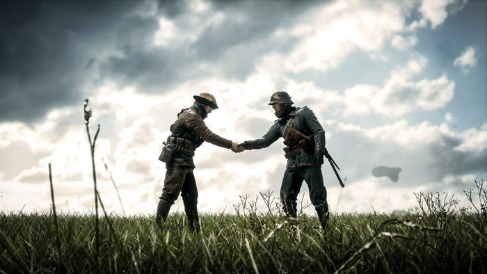 Two soldiers shaking hands in a field