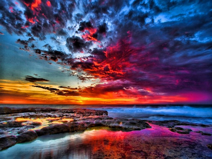 Vivid Sunset Over Rocky Ocean Shore
