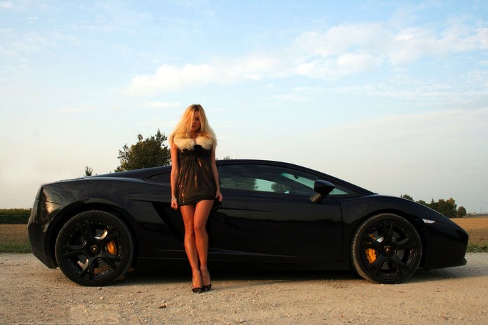 Woman in dress with black Lamborghini