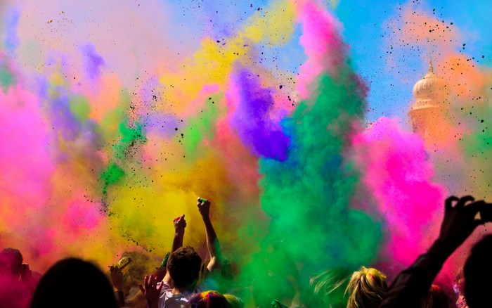 People celebrating Holi with colorful powder
