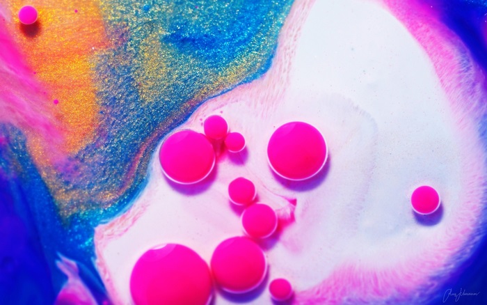 Pink and blue abstract paint with gold glitter