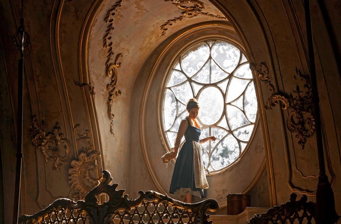 Belle from Beauty and the Beast in a castle
