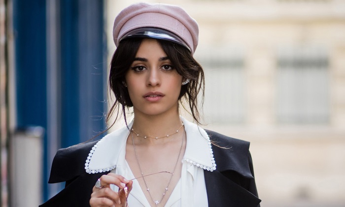 Camila Cabello wearing a hat and jacket
