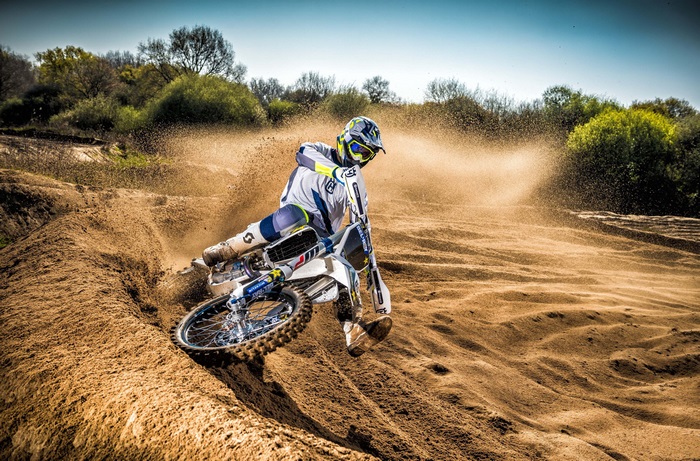 Husqvarna TC250 motocross rider kicking up dirt