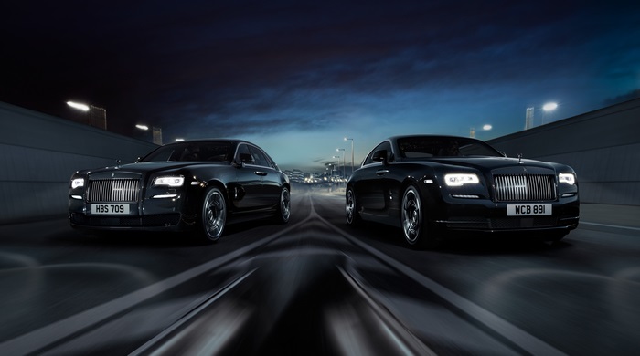 Two Rolls-Royce Wraith Black Badge cars on a road at night