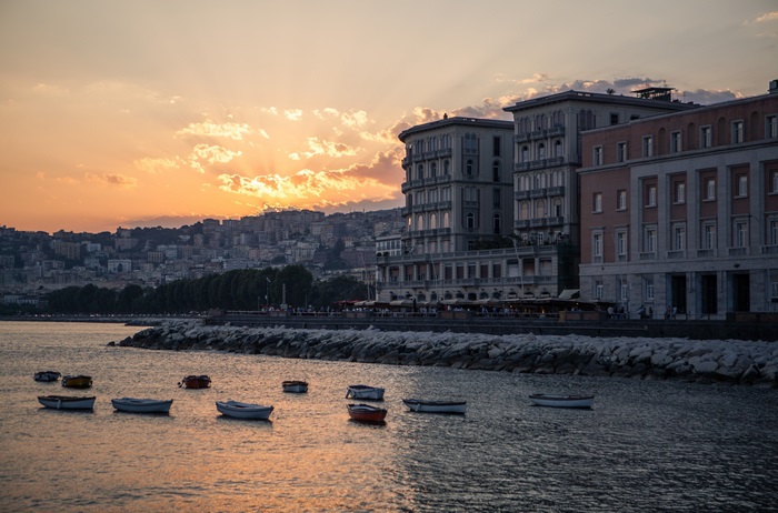 Naples cityscape at sunset with boats