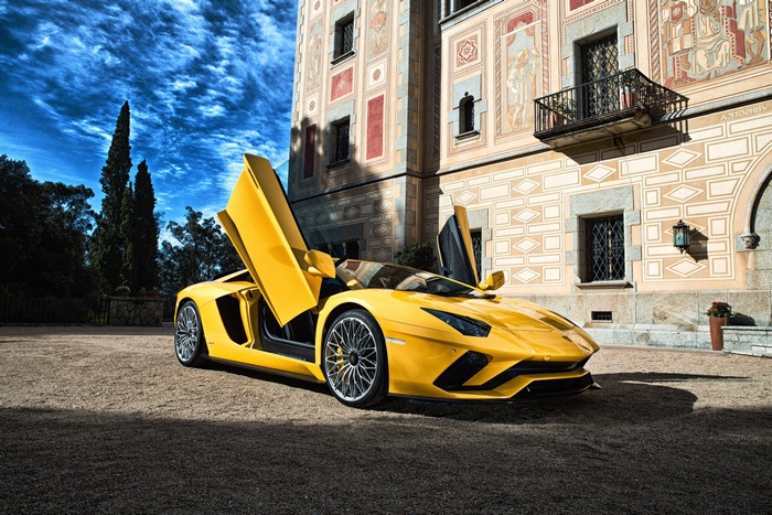 Yellow Lamborghini Aventador with Scissor Doors in Front of Building