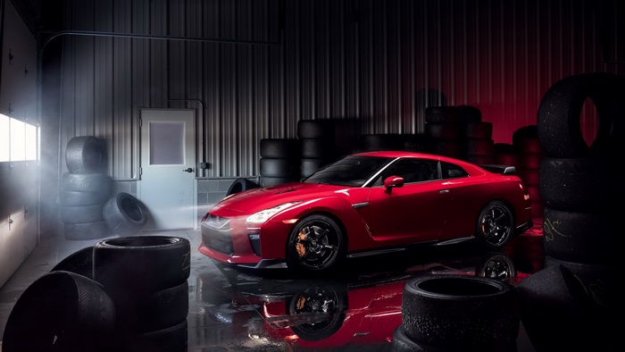 Red Nissan GT-R Track Edition in garage with tires