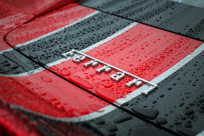 Ferrari logo on a car with water droplets