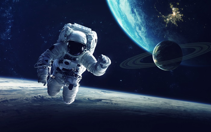 Astronaut in space with planets