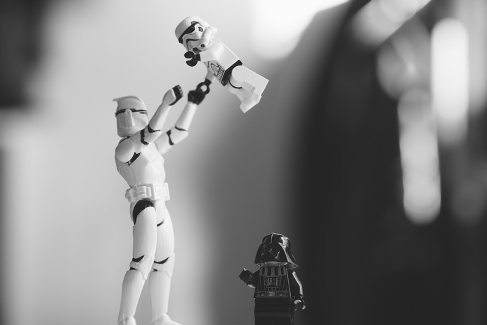 Stormtrooper holding a baby Stormtrooper, Darth Vader