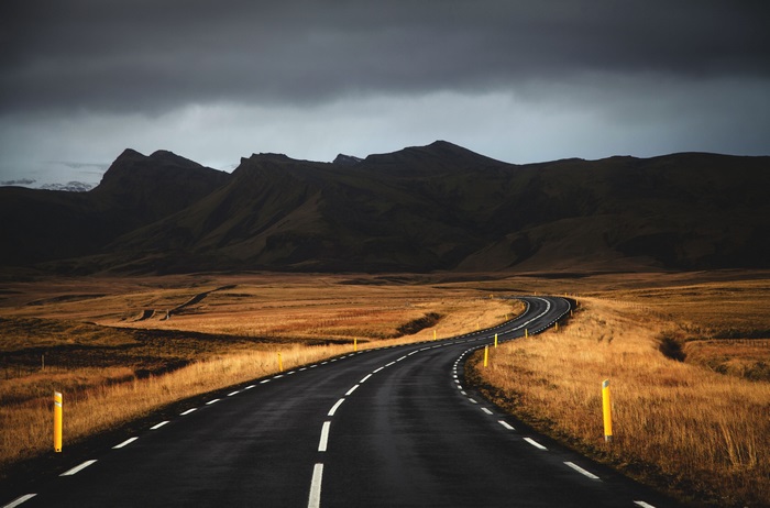 Winding road through Icelandic landscape with mountains