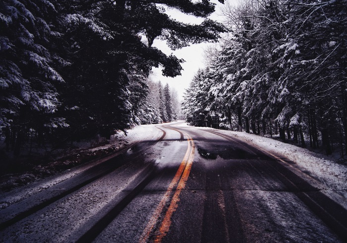 Snowy road through a forest