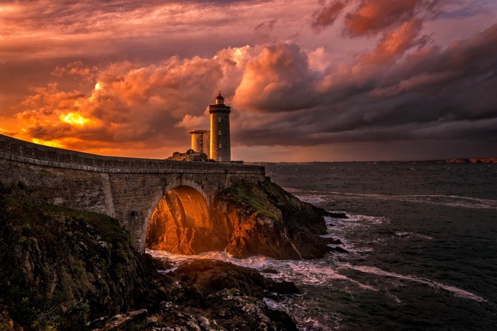 Sunset Lighthouse Over Ocean Bridge