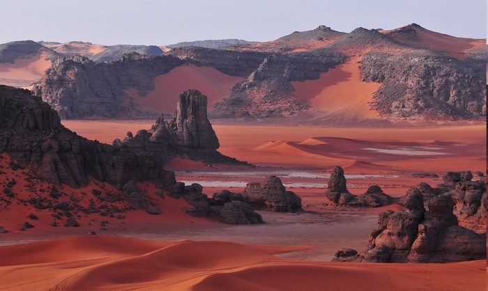 Red desert landscape with rock formations in Algeria