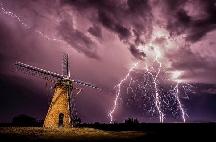 Windmill during a lightning storm at night