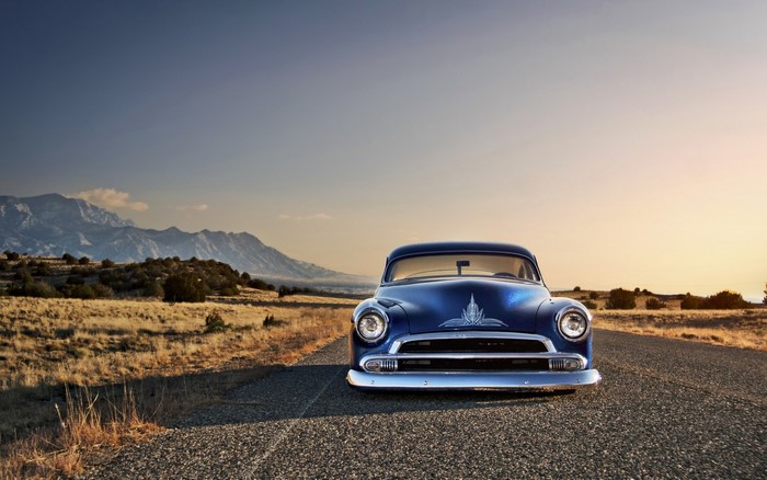 Blue Chevrolet hot rod on a rural road