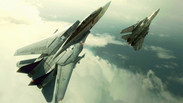 Two F-14 Tomcat fighter jets flying in clouds