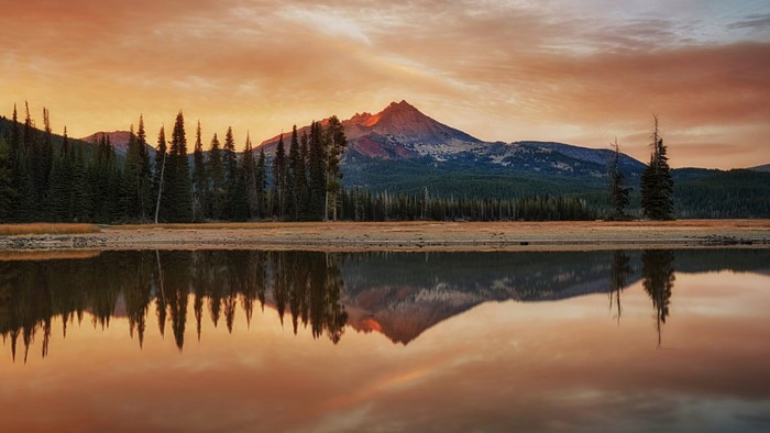 Mountain reflection in lake at sunset