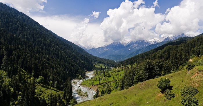Mountain valley with river and snow-capped peaks
