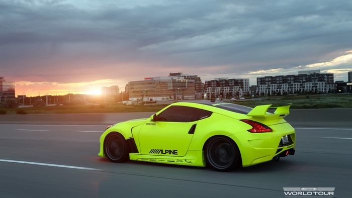 Nissan 370Z with Alpine livery on highway at sunset