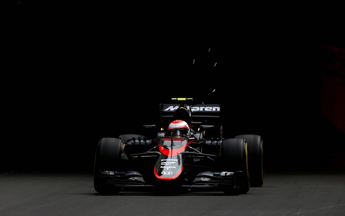 McLaren F1 car with sparks on black background