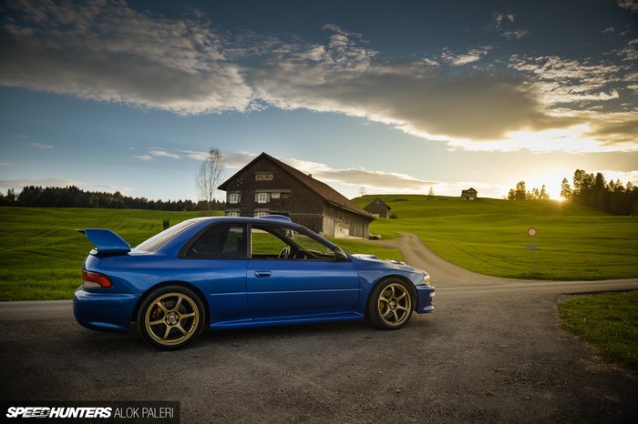 Blue Subaru Impreza WRX STI in a rural landscape