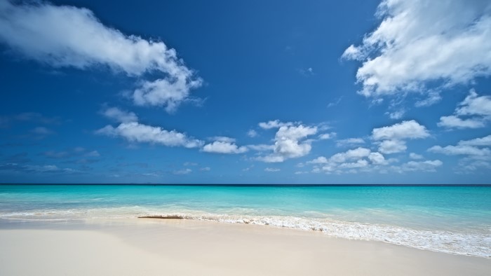 Tropical beach with turquoise water and blue sky