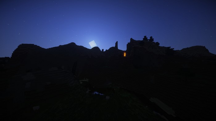 Minecraft landscape at night with moon and lava