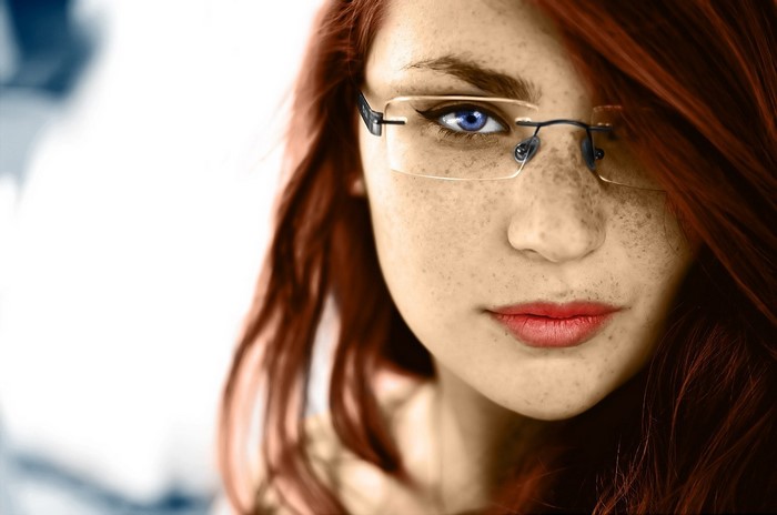 Woman with red hair and glasses