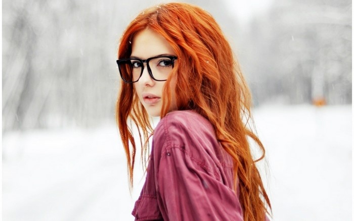 Redhead woman with glasses in the snow