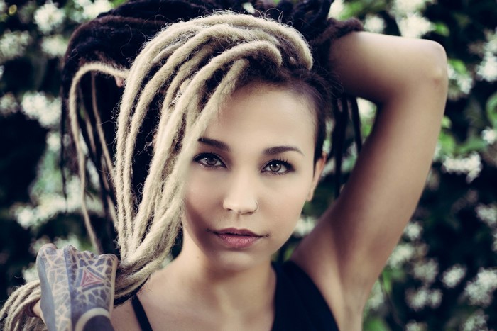 Woman with dreadlocks and tattoos