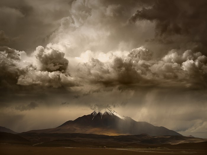 Stormy sky over a snowy mountain peak
