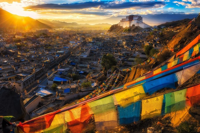 Potala Palace in Lhasa, Tibet at sunset with prayer flags