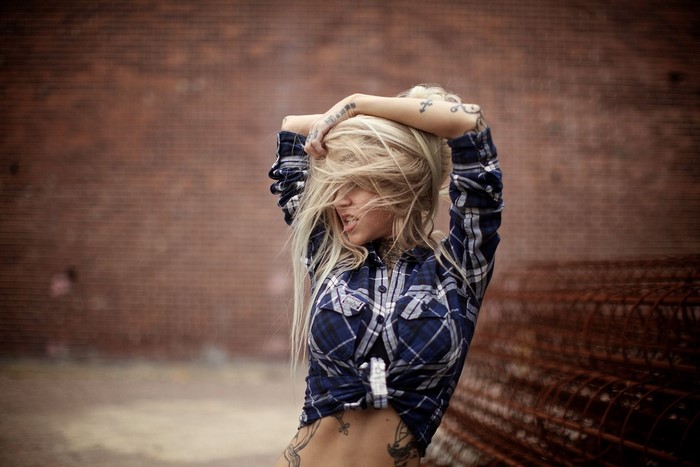 Sara Fabel with blonde hair and tattoos