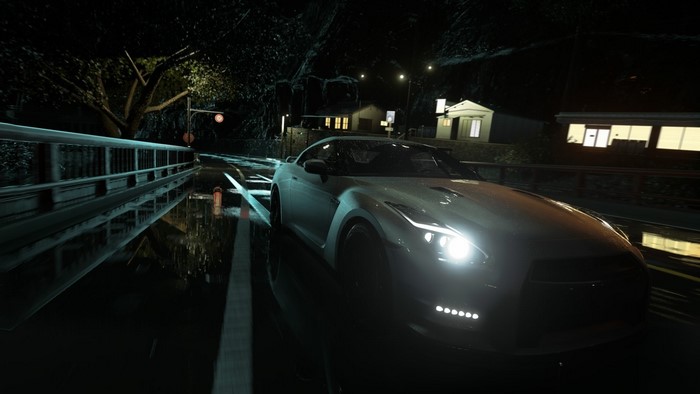 Nissan GT-R R35 driving on a wet road at night